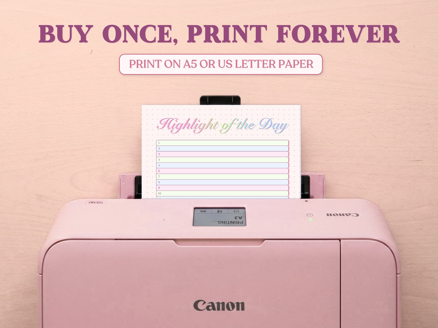 A printable 'Highlight of the Day' tracker page being printed from a pastel pink Canon printer on a light wood desk setup. The image template includes large decorative text overlays saying 'BUY ONCE, PRINT FOREVER' and 'PRINT ON A5 OR US LETTER PAPER' to highlight its printable features for a bullet journal.