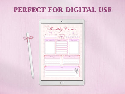 A white tablet showing the monthly review template for a digital bullet journal, accompanied by a white stylus with a pink bow. The text at the top reads 'PERFECT FOR DIGITAL USE' against a textured pink background.