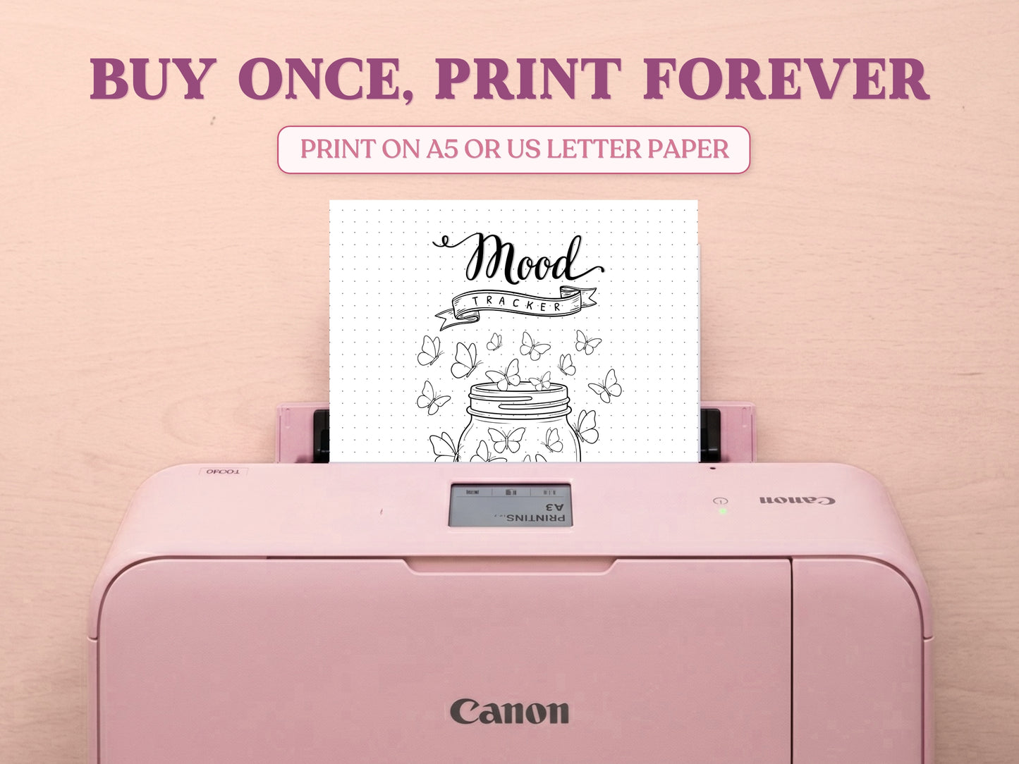 A printable minimalist butterfly jar mood tracker page being printed from a pastel pink Canon printer on a light wood desk setup. The image template includes large decorative text saying 'BUY ONCE, PRINT FOREVER' and 'PRINT ON A5 OR US LETTER PAPER' to highlight its printable features for a bullet journal.