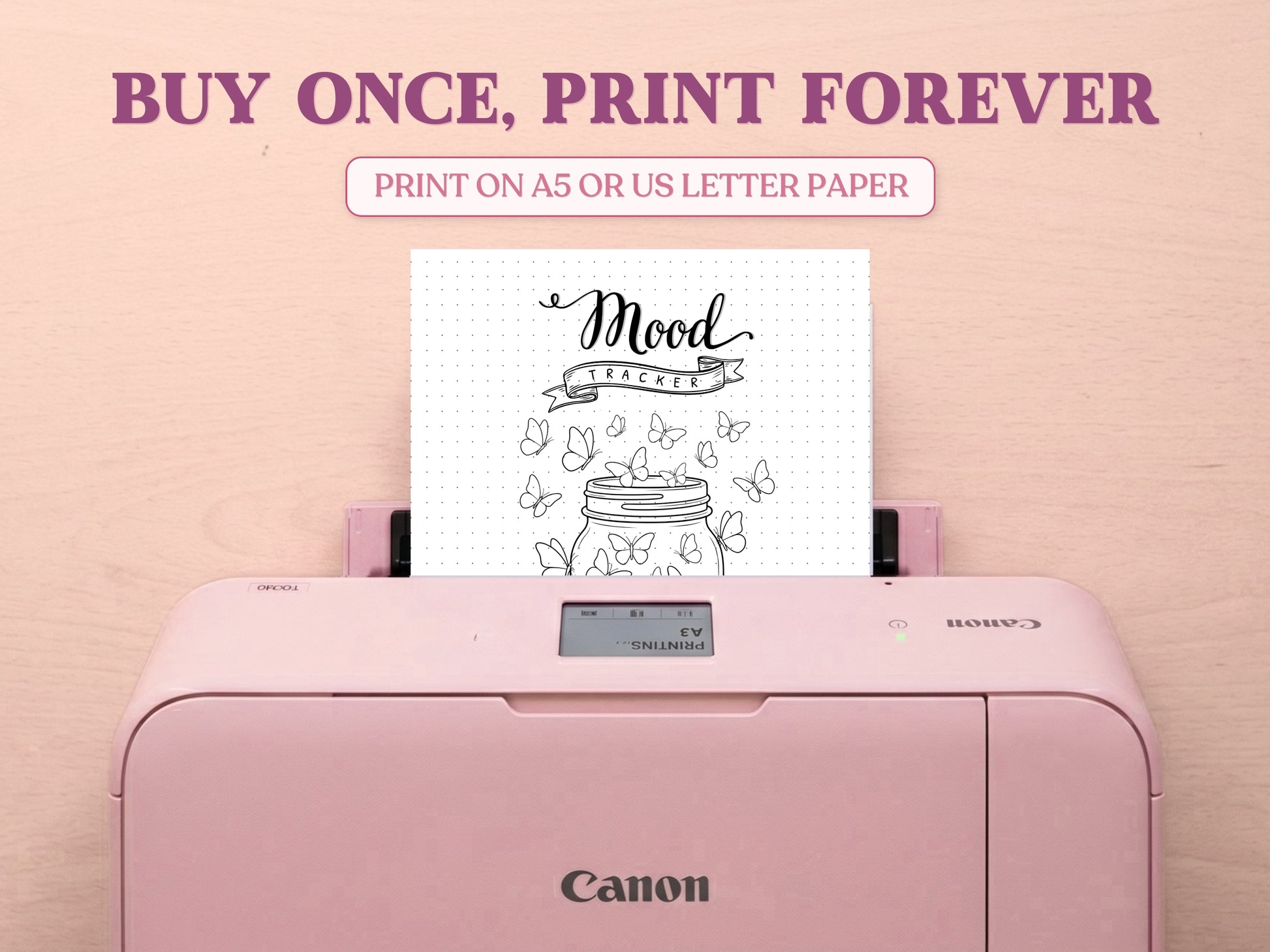 A printable minimalist butterfly jar mood tracker page being printed from a pastel pink Canon printer on a light wood desk setup. The image template includes large decorative text saying 'BUY ONCE, PRINT FOREVER' and 'PRINT ON A5 OR US LETTER PAPER' to highlight its printable features for a bullet journal.
