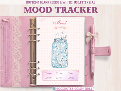 A bullet journal mood tracker page showcased inside a light pink leather binder with lace detailing and a matching pen. Features a cute blue jar illustration filled with outline butterflies to color in, a dotted grid background, and a mood key at the bottom. Labeled as GoodNotes compatible.