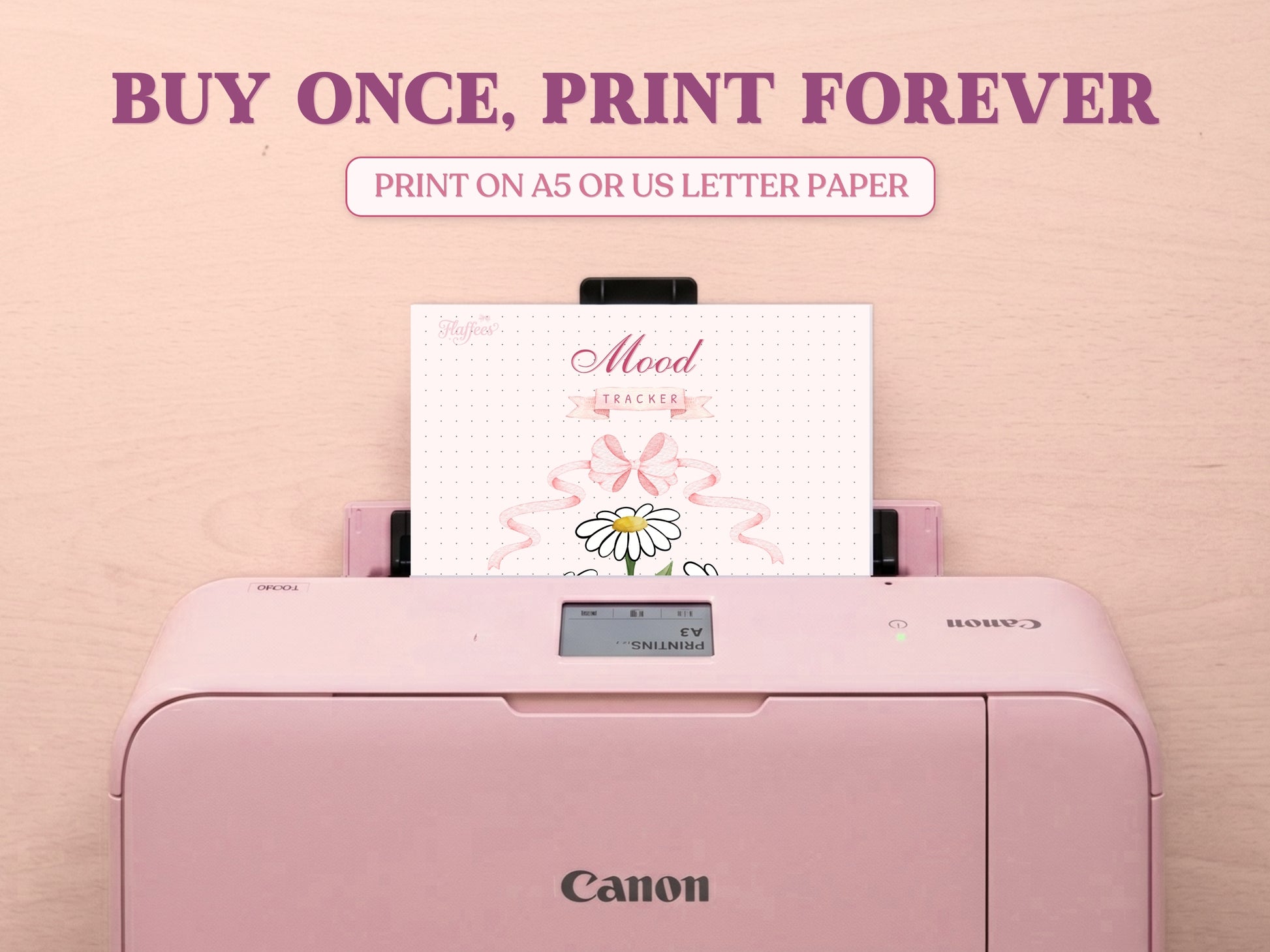 A printable daisy mood tracker page being printed out of a pastel pink Canon printer on a wooden desk. Features large bold text reading 'BUY ONCE, PRINT FOREVER' and 'PRINT ON A5 OR US LETTER PAPER' to highlight its printable features for a bullet journal.