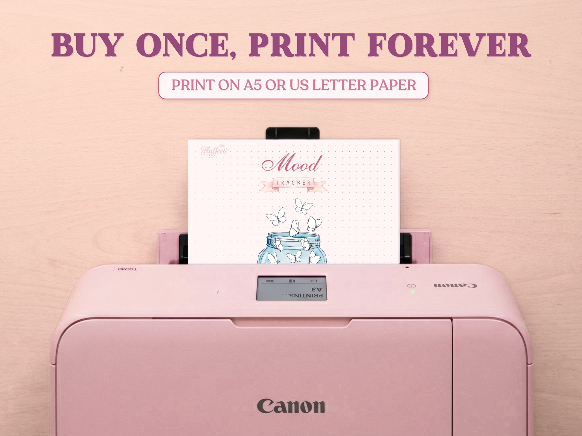 A printable butterfly jar mood tracker page being printed out of a pastel pink Canon printer on a wooden desk. Features large promotional text reading 'BUY ONCE, PRINT FOREVER' and 'PRINT ON A5 OR US LETTER PAPER' to emphasize it is a printable bullet journal template.
