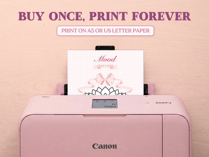 A printable seashell mood tracker page coming out of a pastel pink Canon printer on a wooden desk. The headline says 'BUY ONCE, PRINT FOREVER' and 'PRINT ON A5 OR US LETTER PAPER', emphasizing the printable nature of this bullet journal template.