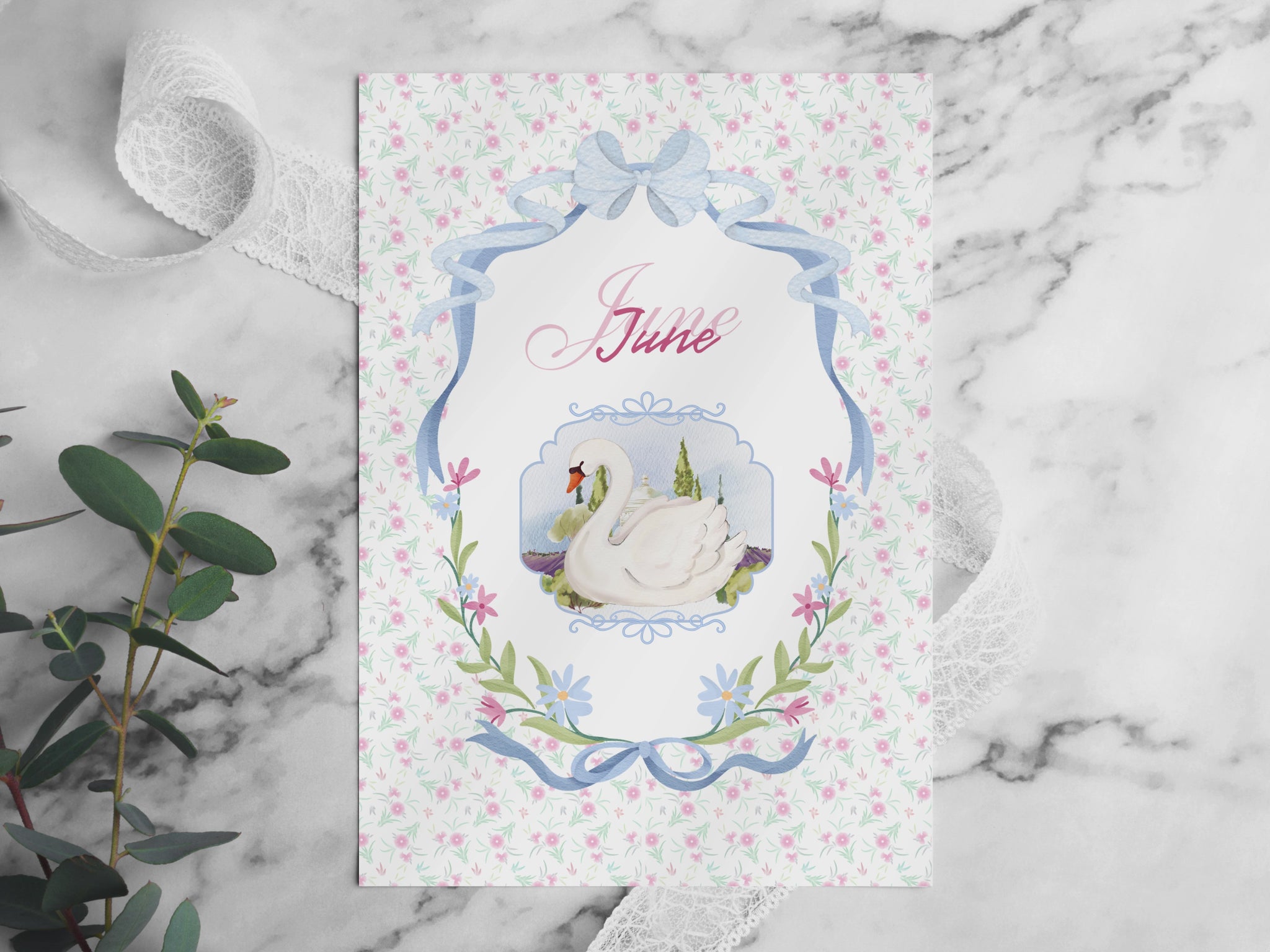 A video flip-through of the June Bullet Journal pages placed on a white marble table. The video showcases various layouts including the swan cover, habit trackers, and workout challenges in a soft pink aesthetic. Surrounded by decorative elements like eucalyptus, lace, and pearls in bright, natural light.